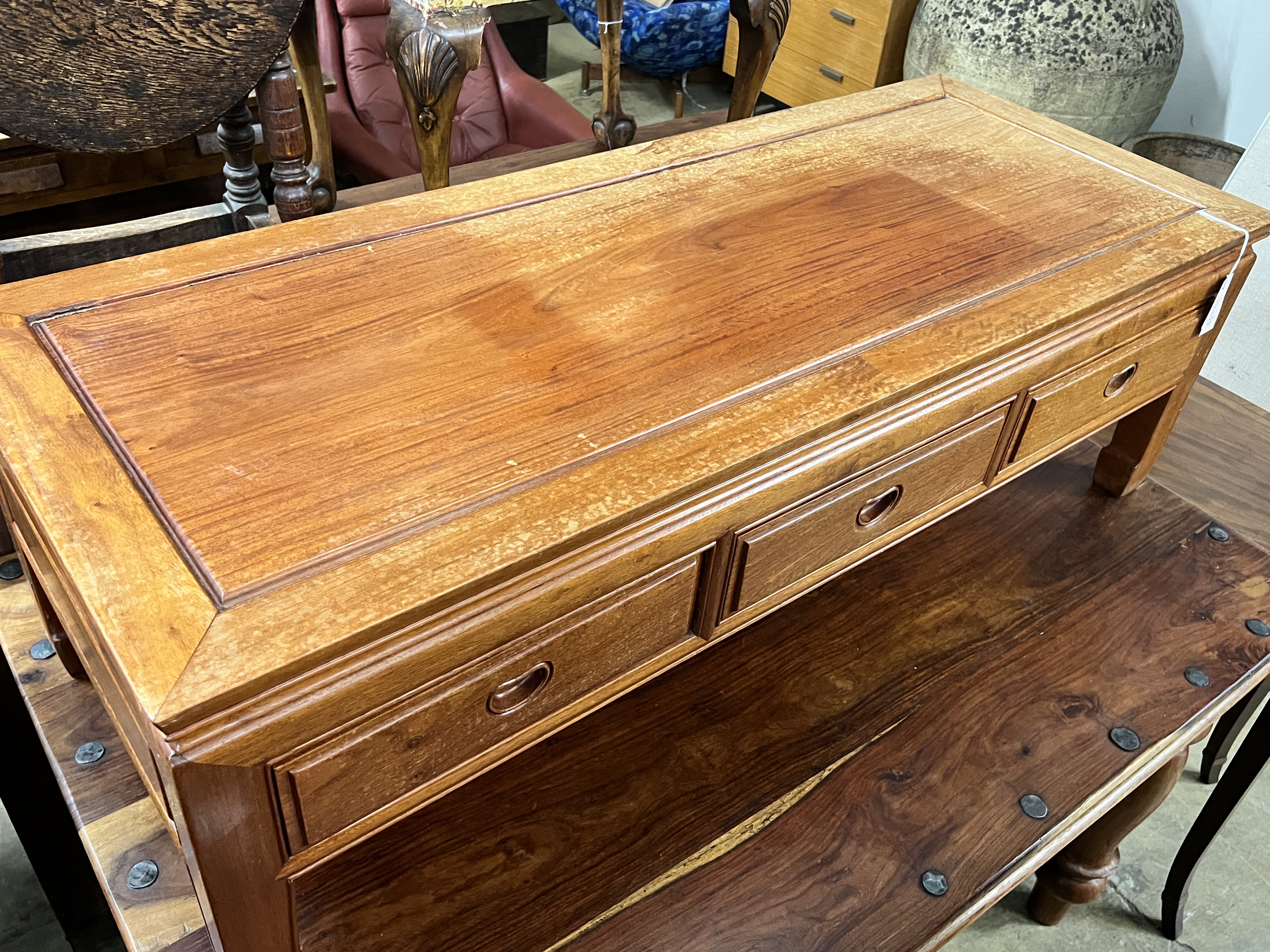 A Chinese rectangular hardwood three drawer coffee table, width 127cm, depth 50cm, height 40cm